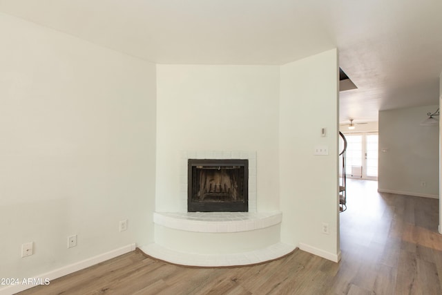 details featuring french doors, hardwood / wood-style flooring, and a brick fireplace