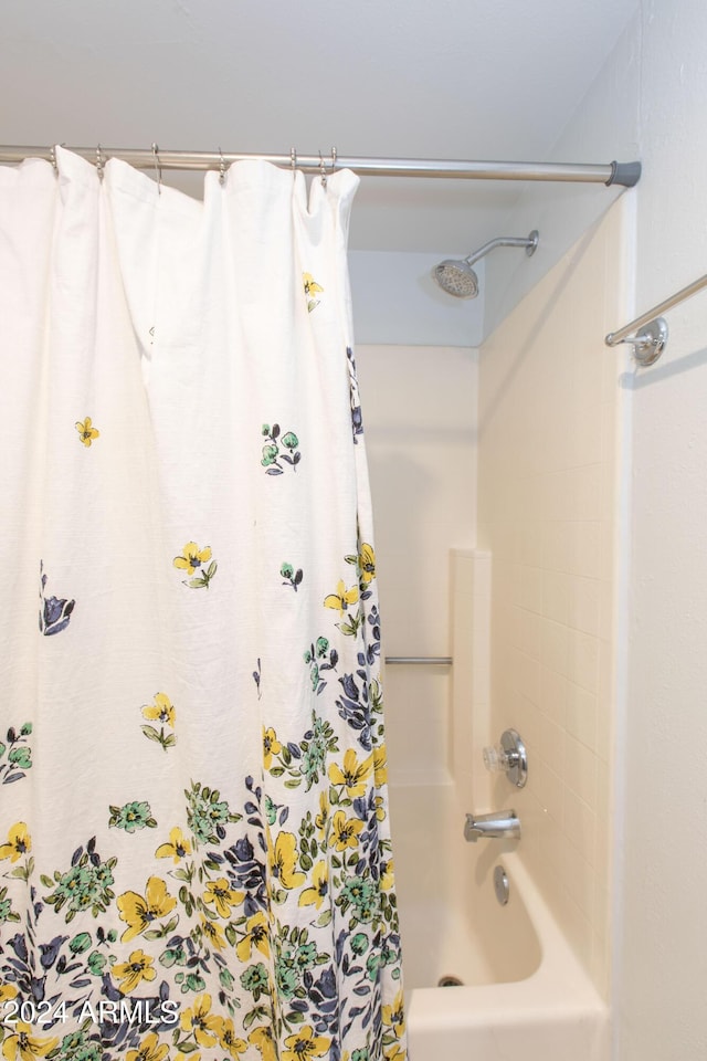 bathroom with shower / bath combo with shower curtain