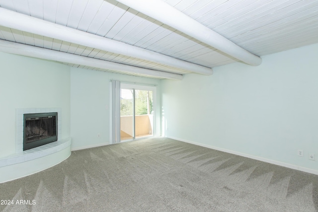 unfurnished living room with carpet and beam ceiling