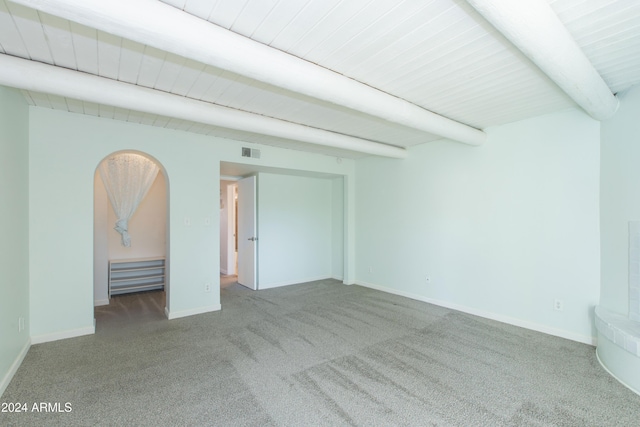 interior space featuring beamed ceiling and light colored carpet