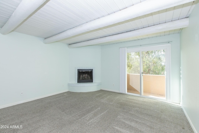 unfurnished living room featuring beam ceiling and carpet floors