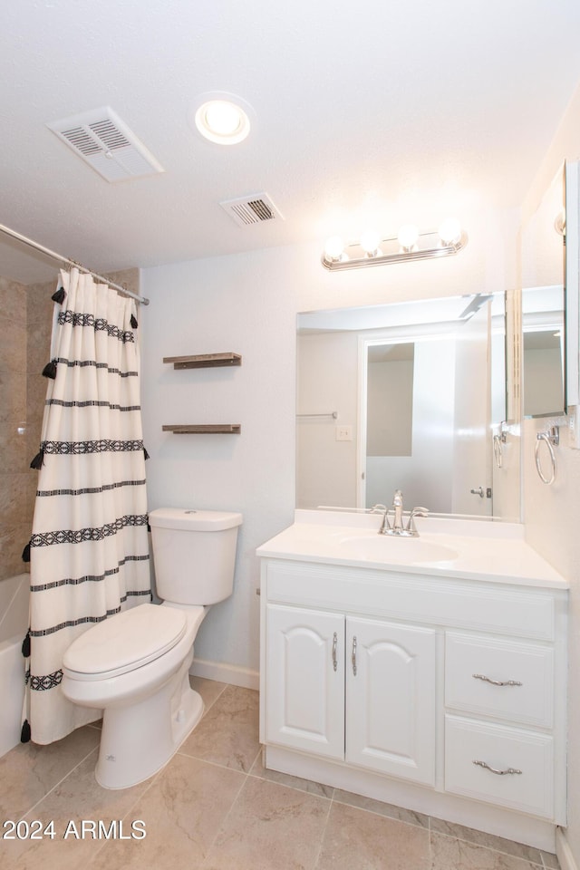 full bathroom with vanity, shower / tub combo, and toilet