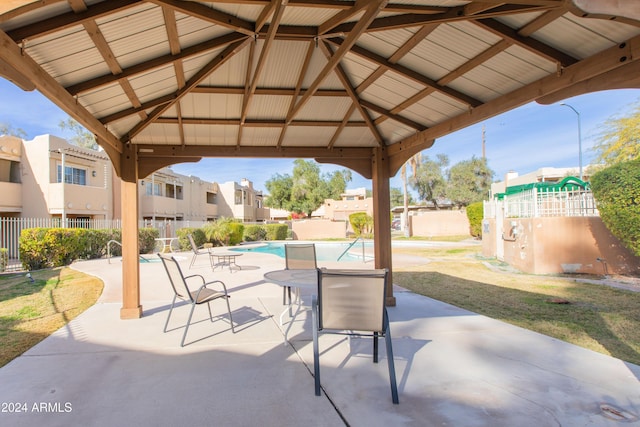 view of patio with a gazebo and a community pool