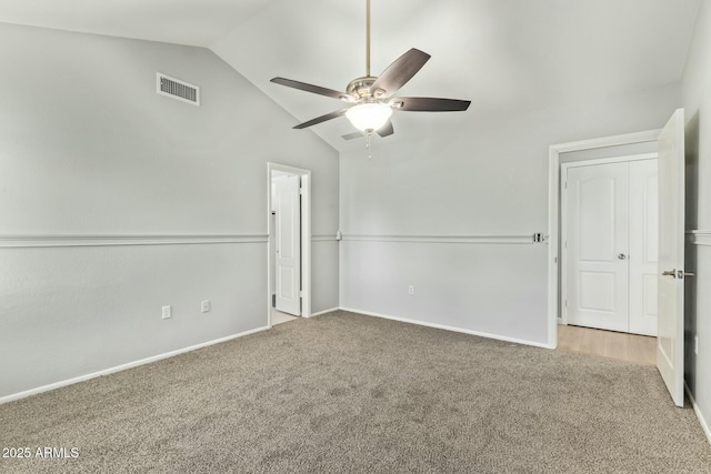 unfurnished bedroom featuring vaulted ceiling, ceiling fan, visible vents, and carpet floors