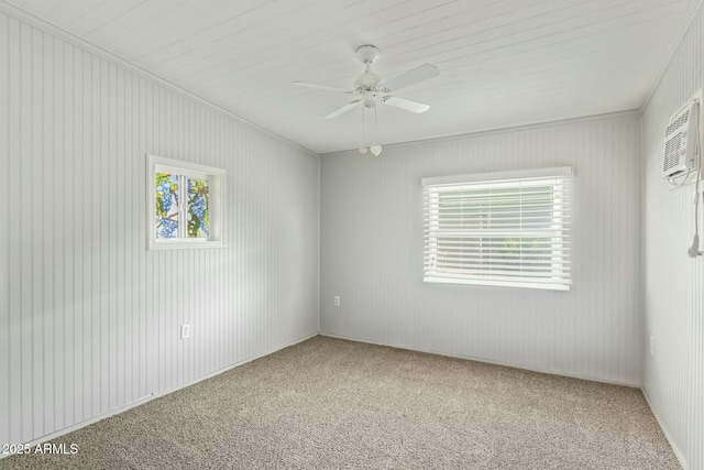 carpeted spare room with plenty of natural light, a ceiling fan, a wall mounted air conditioner, and ornamental molding