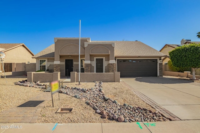 view of front facade featuring stucco siding, concrete driveway, stone siding, a garage, and a fenced front yard