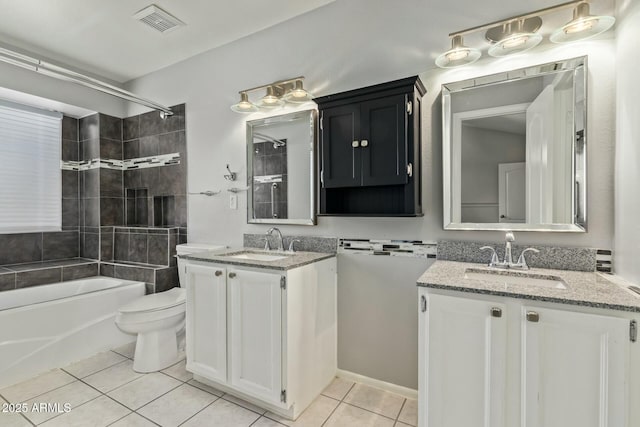 full bathroom featuring tile patterned flooring, toilet, visible vents, and a sink