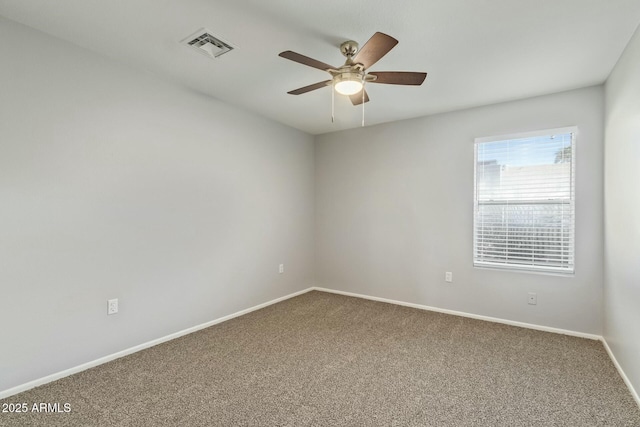 unfurnished room featuring a ceiling fan, carpet flooring, baseboards, and visible vents