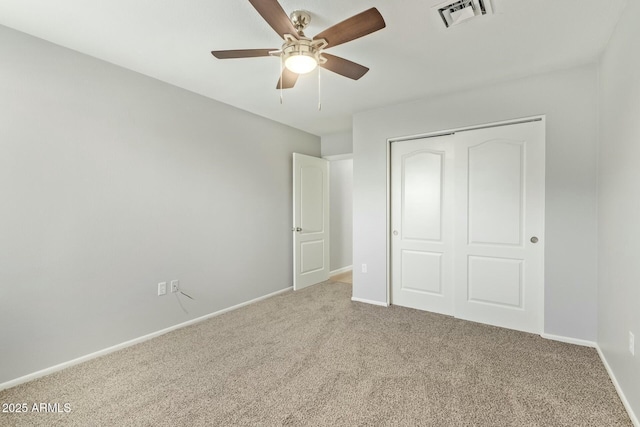 unfurnished bedroom featuring a ceiling fan, baseboards, visible vents, carpet floors, and a closet