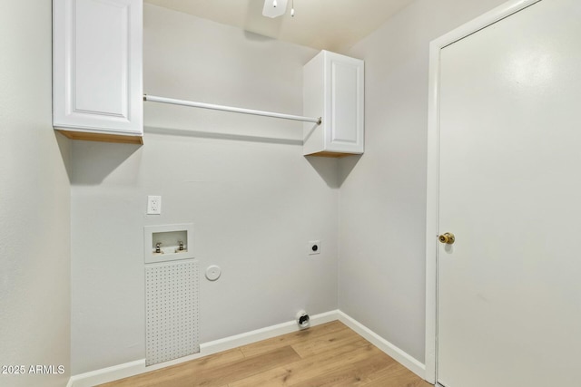 laundry room with electric dryer hookup, cabinet space, light wood-style floors, baseboards, and hookup for a washing machine