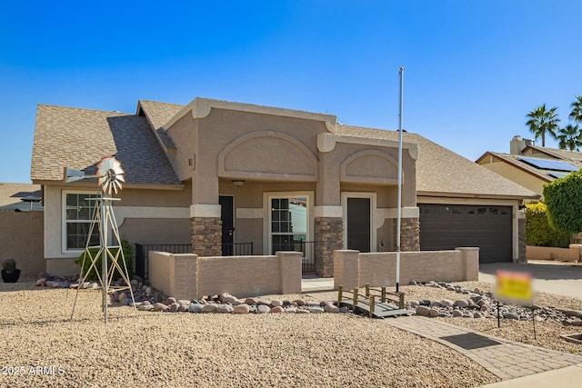 view of front of home with a fenced front yard, roof with shingles, stucco siding, stone siding, and an attached garage