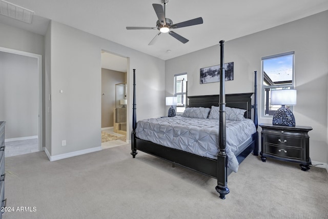 carpeted bedroom featuring ensuite bathroom and ceiling fan