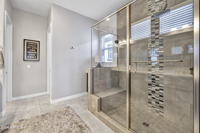 bathroom with tile patterned flooring and a shower with door