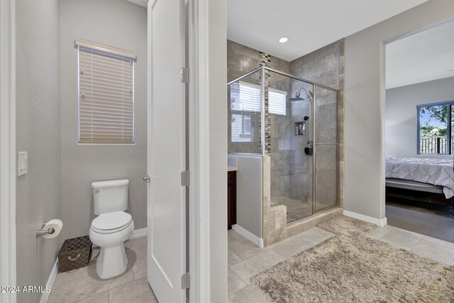 bathroom with tile patterned flooring, toilet, and walk in shower