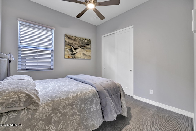 bedroom featuring ceiling fan, a closet, and dark colored carpet