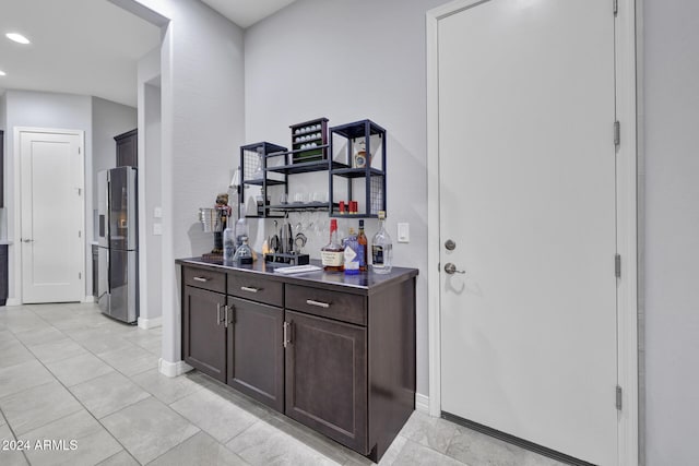 interior space with stainless steel fridge and dark brown cabinets