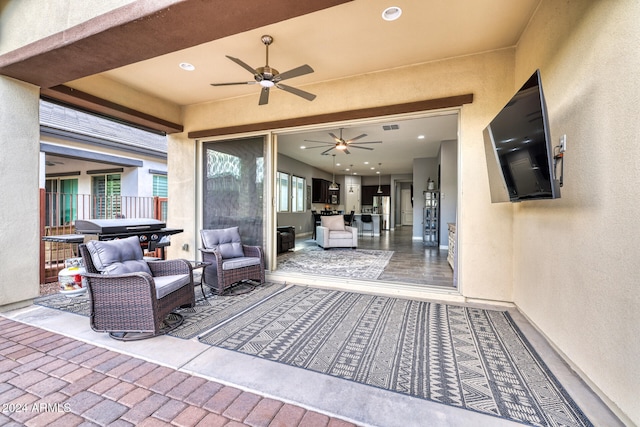 view of patio / terrace with area for grilling, ceiling fan, and an outdoor hangout area