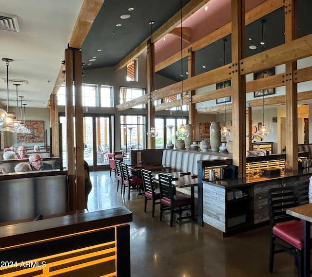 interior space with pendant lighting and a high ceiling