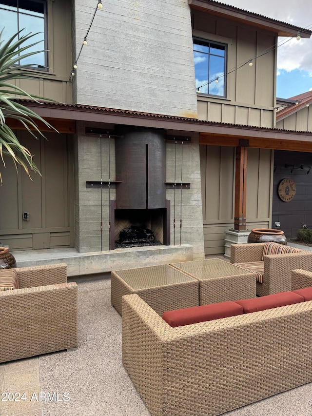 view of patio with an outdoor living space with a fireplace