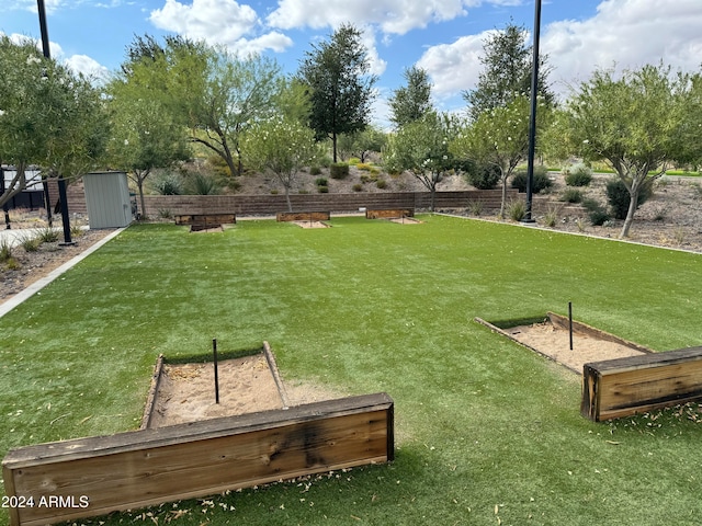 surrounding community featuring a yard and a shed