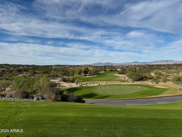 view of home's community featuring a mountain view and a yard