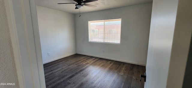 unfurnished room featuring dark wood-type flooring and ceiling fan