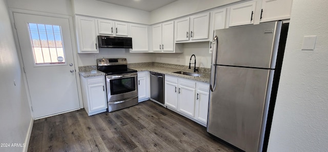 kitchen with light stone counters, sink, white cabinetry, and appliances with stainless steel finishes