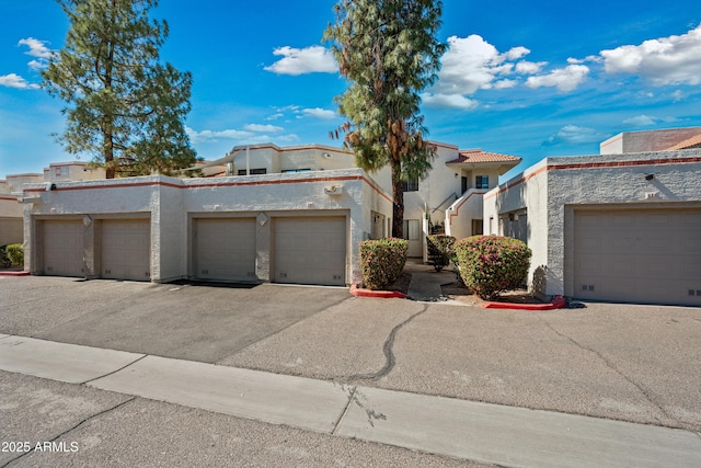 townhome / multi-family property with stucco siding and community garages