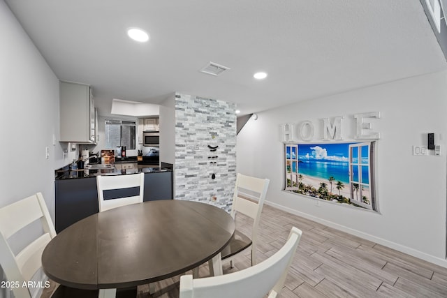 dining room with wood finish floors, visible vents, baseboards, and recessed lighting