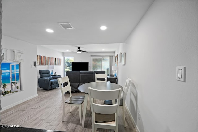 dining room featuring light wood-type flooring, visible vents, baseboards, and recessed lighting