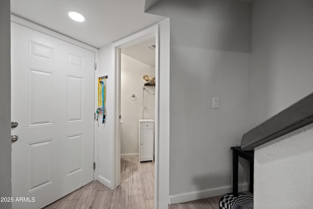 entryway with light wood-style floors, visible vents, and baseboards