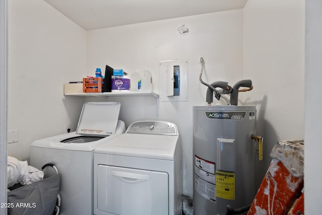 clothes washing area with laundry area, water heater, and washing machine and clothes dryer