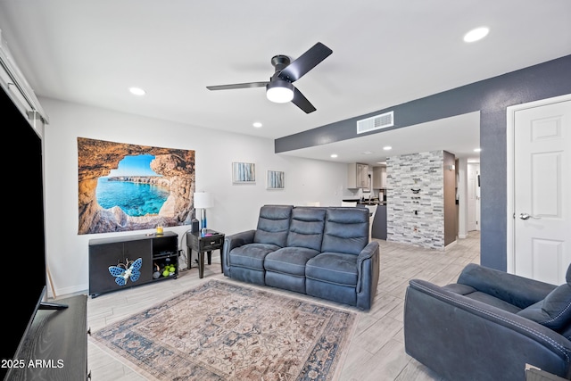 living room with a ceiling fan, recessed lighting, visible vents, and wood finish floors