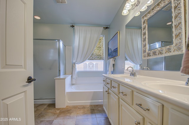 bathroom featuring double vanity, a bath, tile patterned floors, and a sink