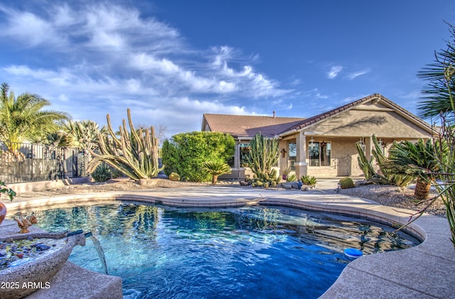 view of pool with a fenced in pool and fence