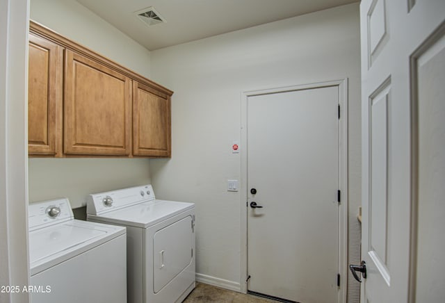 clothes washing area with visible vents, cabinet space, baseboards, and washing machine and dryer