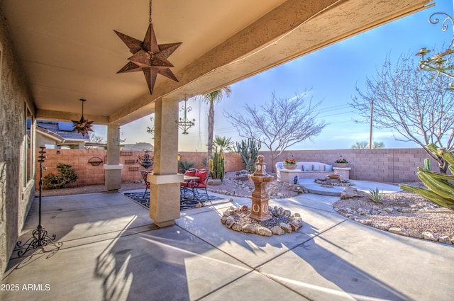 view of patio / terrace featuring a fenced backyard and a ceiling fan