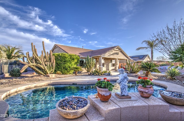 outdoor pool with a patio and fence