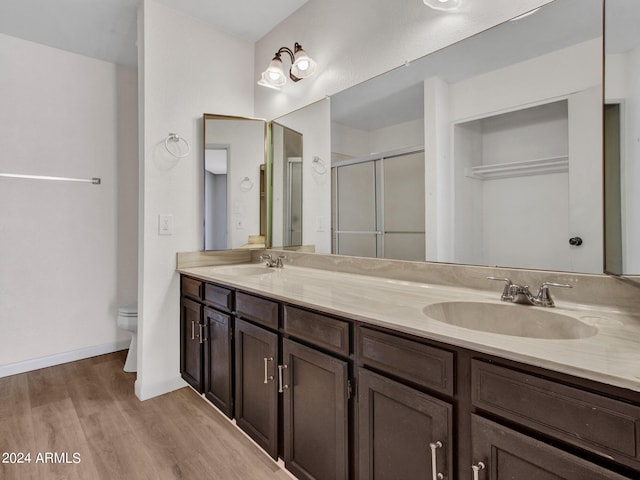 17838 N 45th Ave, Glendale, AZ 85308 - bathroom featuring double vanity, wood finished floors, a shower stall, and a sink