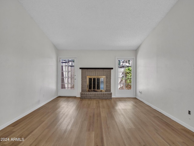 17838 N 45th Ave, Glendale, AZ 85308 - unfurnished living room with a fireplace, light wood-style flooring, and baseboards