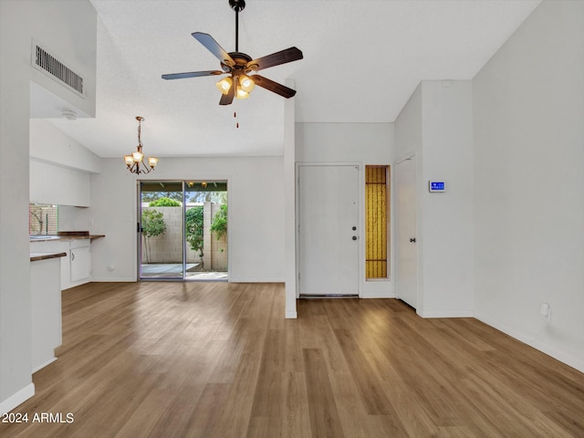 17838 N 45th Ave, Glendale, AZ 85308 - unfurnished living room with visible vents, baseboards, wood finished floors, and ceiling fan with notable chandelier