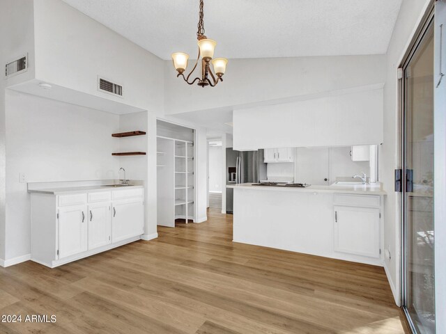17838 N 45th Ave, Glendale, AZ 85308 - kitchen with a peninsula, visible vents, stainless steel refrigerator with ice dispenser, and white cabinetry