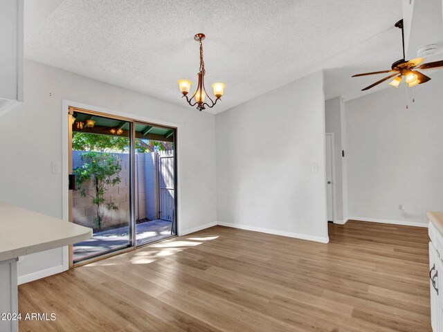 17838 N 45th Ave, Glendale, AZ 85308 - unfurnished dining area featuring baseboards, ceiling fan with notable chandelier, light wood-style floors, and a textured ceiling