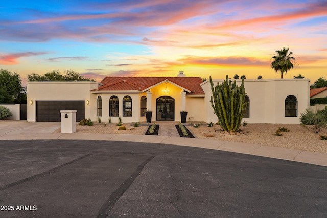 14401 N 60th Pl, Scottsdale, AZ 85254 - mediterranean / spanish home with a tile roof, an attached garage, stucco siding, french doors, and concrete driveway