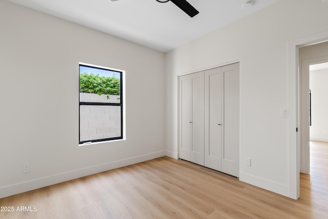 14401 N 60th Pl, Scottsdale, AZ 85254 - unfurnished bedroom featuring light wood-type flooring, a closet, and a ceiling fan