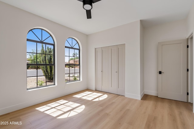 14401 N 60th Pl, Scottsdale, AZ 85254 - unfurnished bedroom with light wood-style flooring, a closet, and a ceiling fan