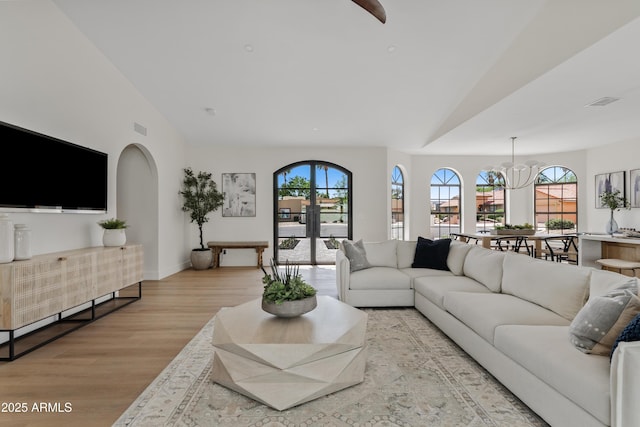 14401 N 60th Pl, Scottsdale, AZ 85254 - living room with vaulted ceiling, wood finished floors, plenty of natural light, arched walkways, and a chandelier
