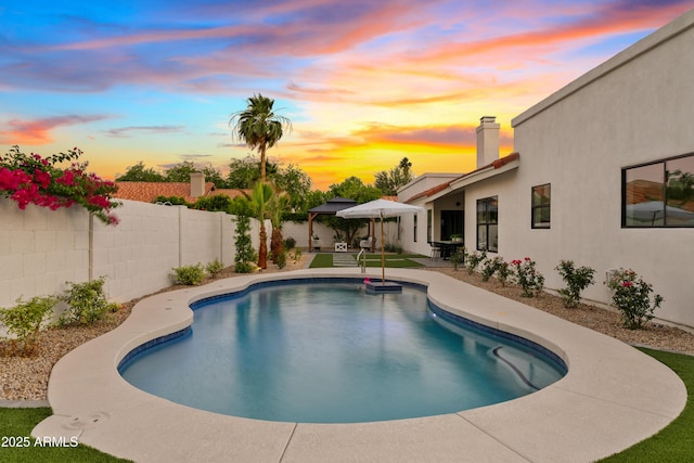 14401 N 60th Pl, Scottsdale, AZ 85254 - pool at dusk featuring a patio area, a fenced backyard, and a gazebo