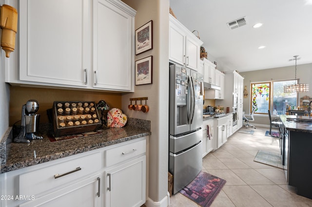 kitchen featuring pendant lighting, white cabinets, sink, stainless steel fridge, and light tile patterned flooring