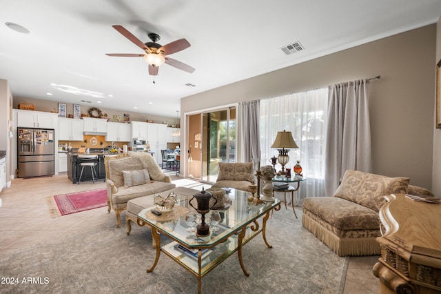 tiled living room with ceiling fan